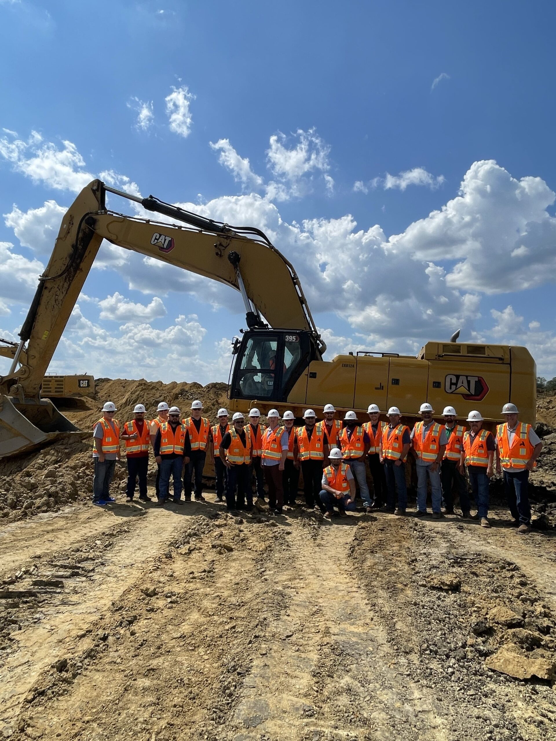 Group photo near excavator